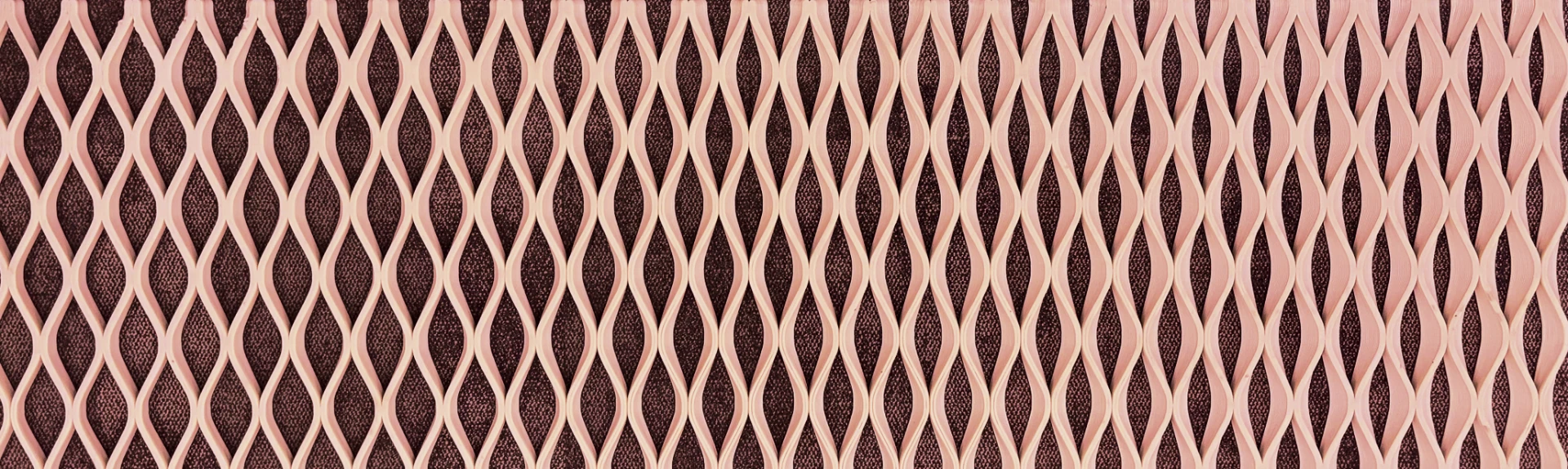Blush pink 3D printed lattice screen panel with a repeating woven diamond pattern