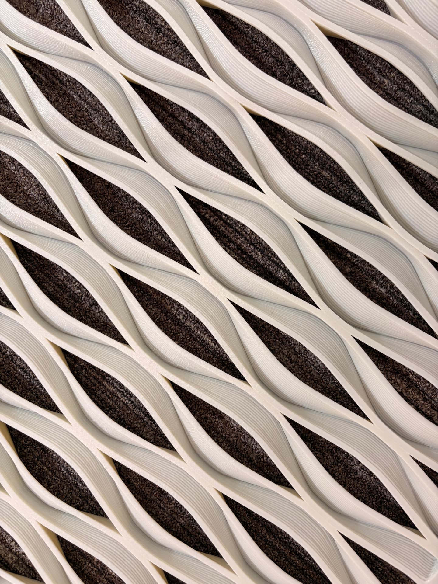 Close-up of a large format 3D printed architectural scale texture with flowing white layers